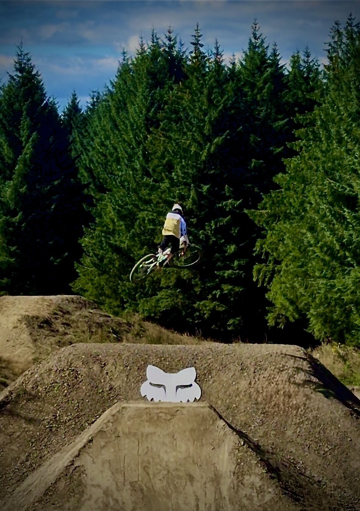Stanlie Britt airborne over a dirt jump