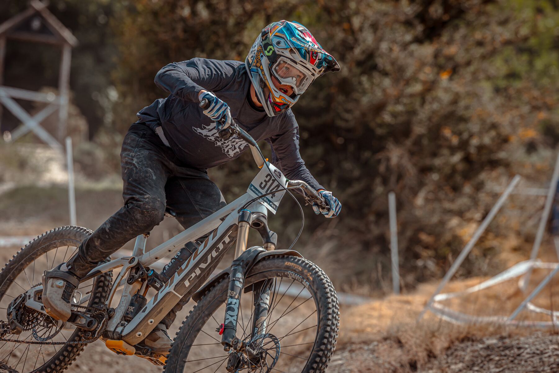 Stanlie Britt cornering hard on a downhill track
